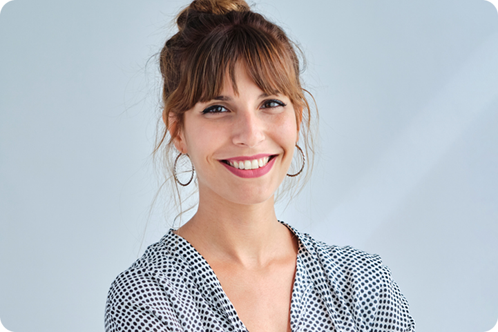 A smiling woman poses confidently, representing a customer exploring client financing options for medical payments.