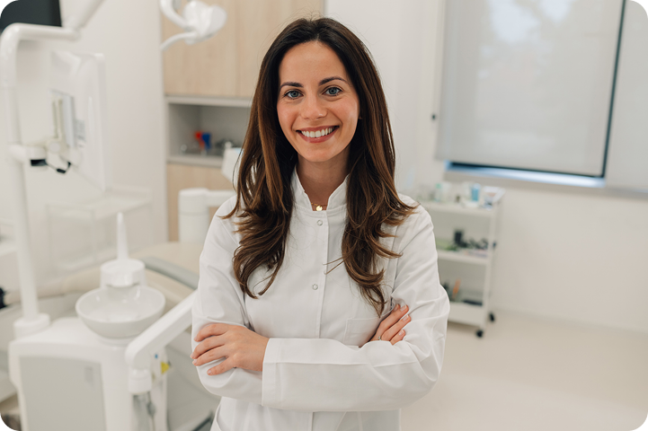 A smiling healthcare provider stands in a medical office, representing third-party financing options for patient payments.