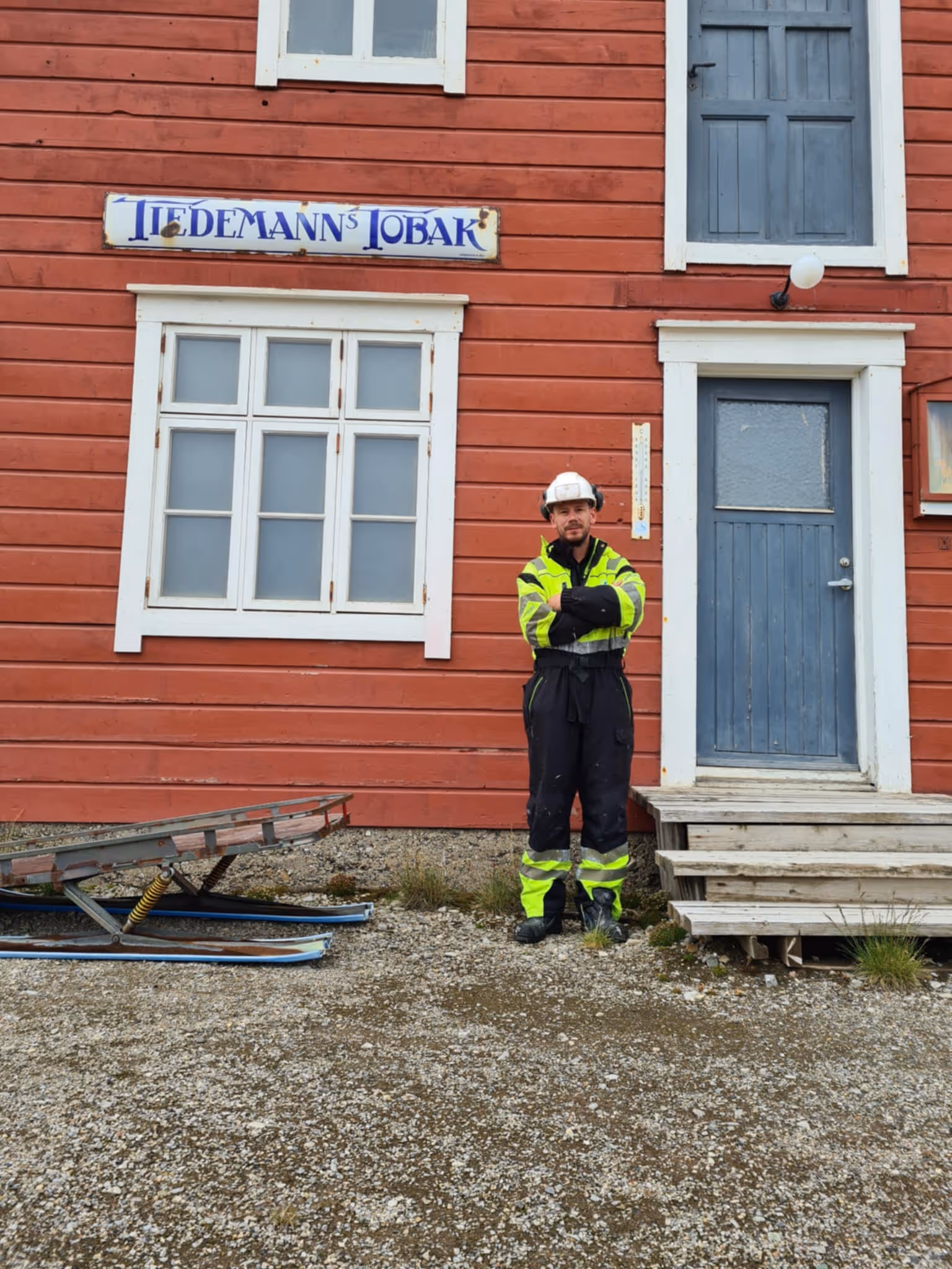 Vegard Eide working in Svalbard. Shown infront of a hotel