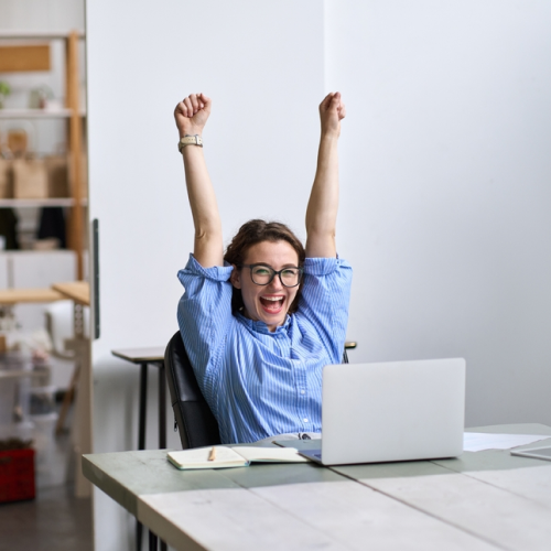 Finance professional working on a laptop at an outdoor café, representing cloud-based invoice processing software and remote accounts payable work.