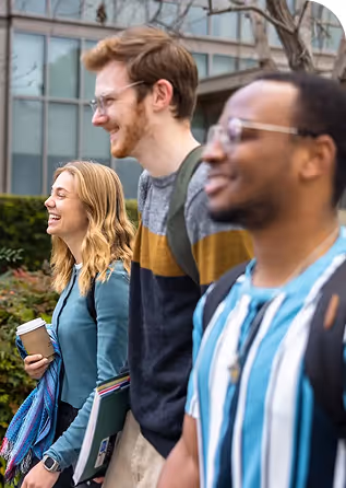 Three young adults, likely college students, are walking and interacting. 