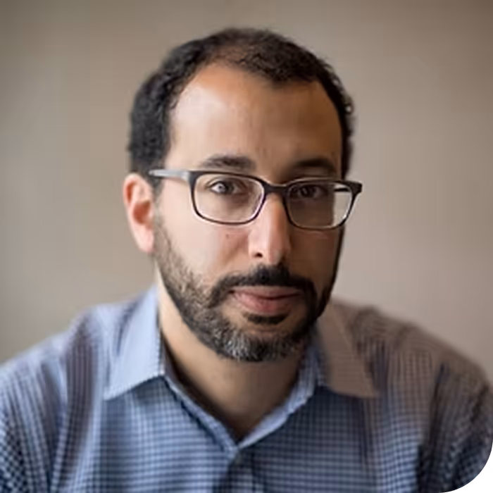 A professor stares at the camera.