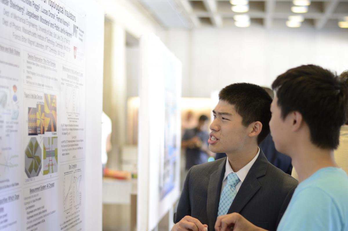 Student presenting at a poster session