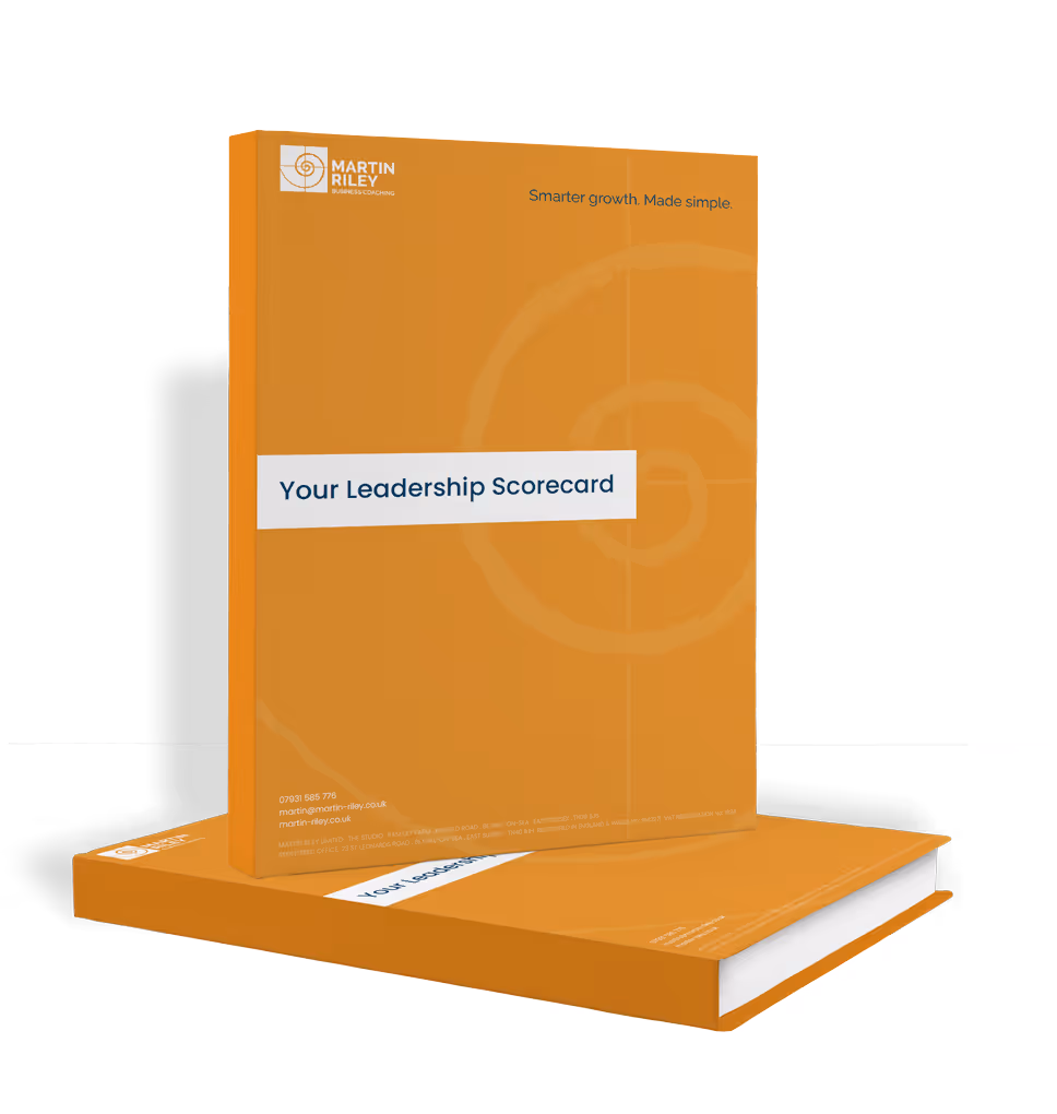 Two orange books titled "Your Leadership Scorecard" with a spiral design on the cover.
