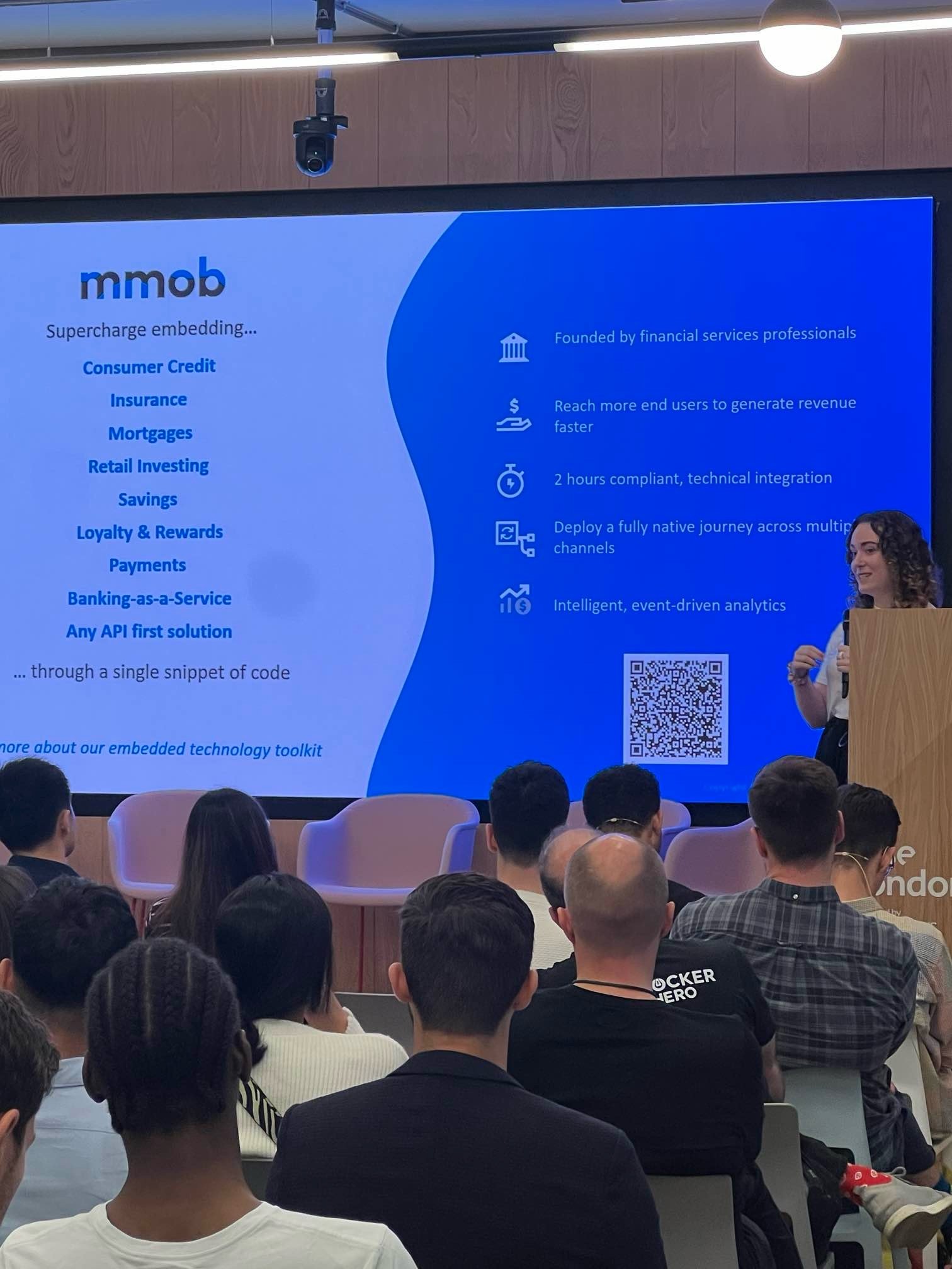 Olivia Minnock pitching at Rise London, showing a slide with a variety of products like mortgages, BaaS, loyalty, payments and insurance.