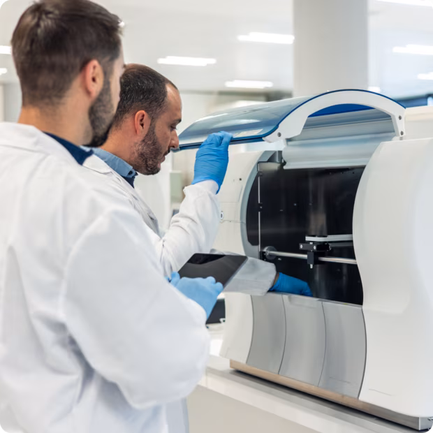 two biomed workers completing a inspection on a medical device.
