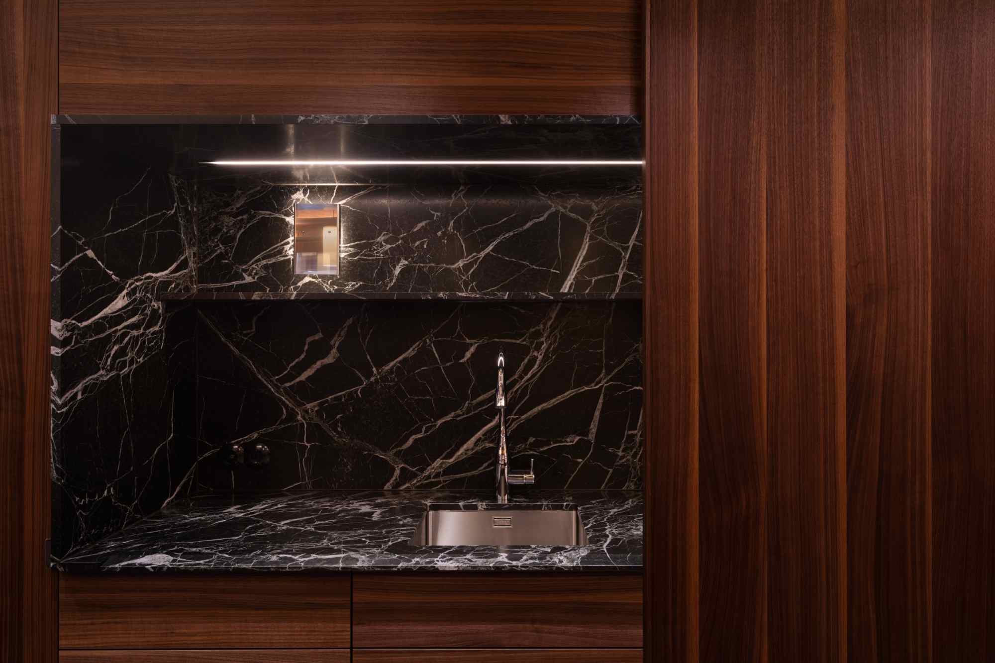Detail eines Weinkühlschranks mit dunkler Marmorblende