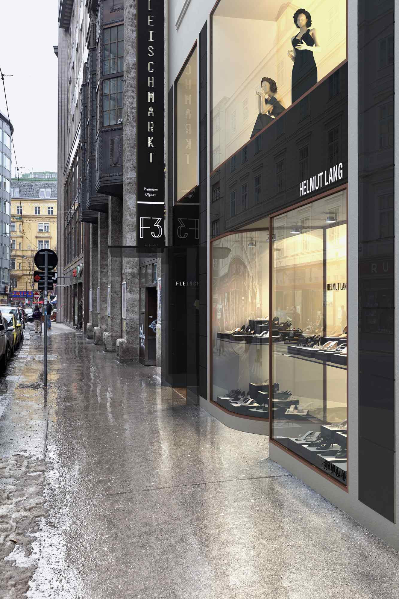 Außenansicht bei Regen des Gebäudes Fleischmarkt 1 mit beleuchtetem Schaufenster