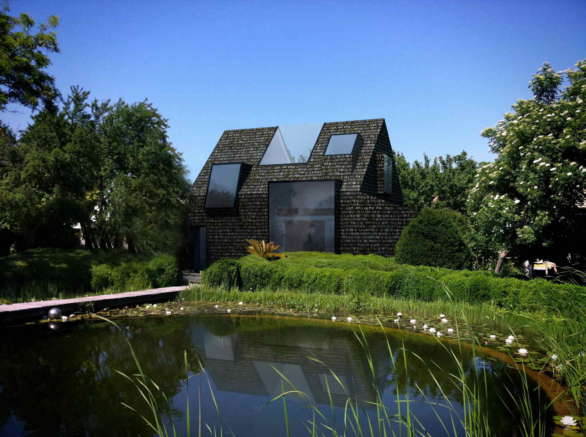 Ansicht des Hauses aus leicht verändertem Winkel – Spiegelung im davorliegenden Teich, umgeben von Bäumen und Hecken.