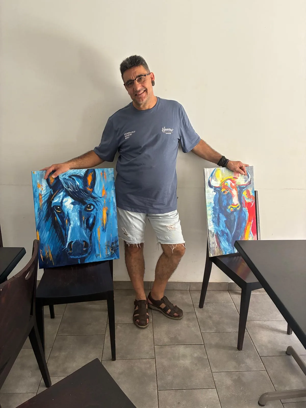 Francisco Javier Seguí García con sus cuadros de un caballo y un toro