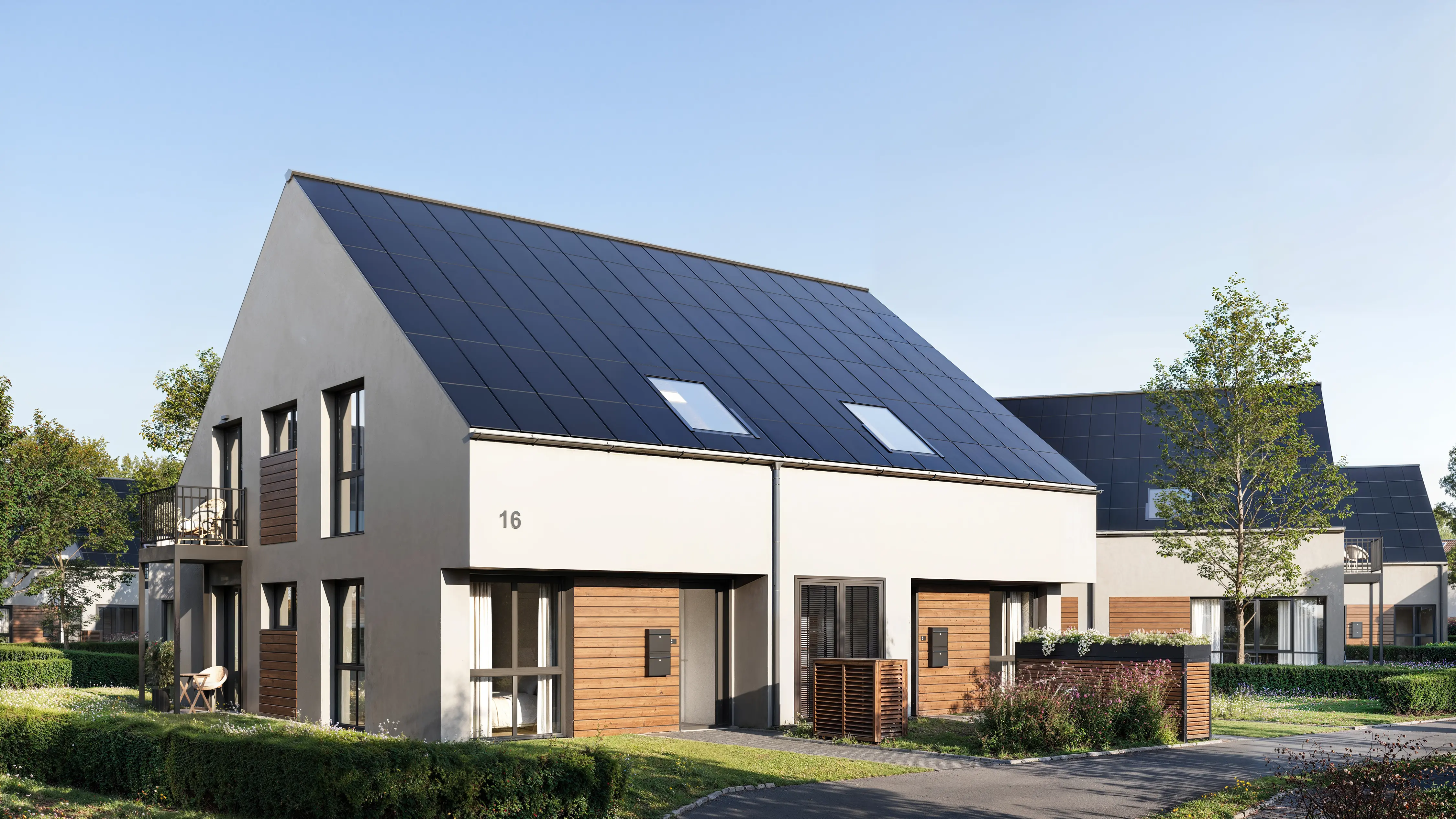 Angled view of two-story house facades and entrance groups.