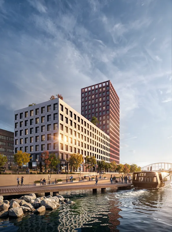 Waterfront view of a modern residential complex as seen from a wooden pier.