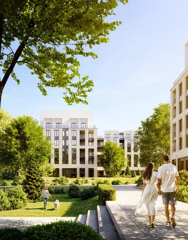 Bright summer day at residential complex featuring walking paths and greenery
