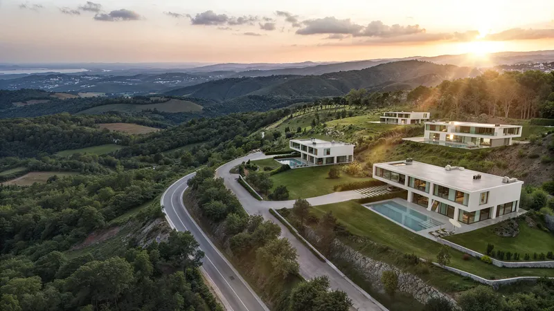 Luxury hillside villa complex glowing in the warm light of a sunset.