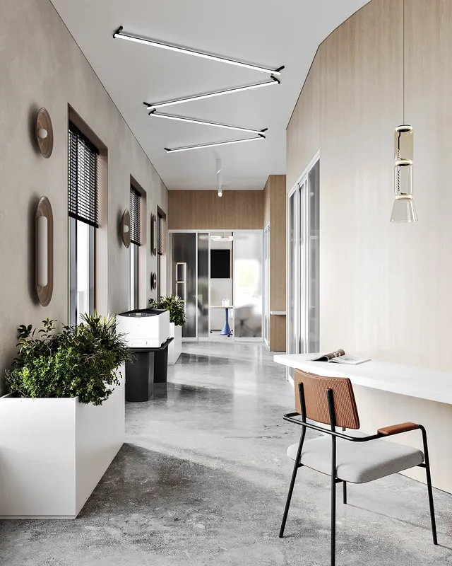 Office corridor leading to meeting rooms, featuring a central print and copy station.