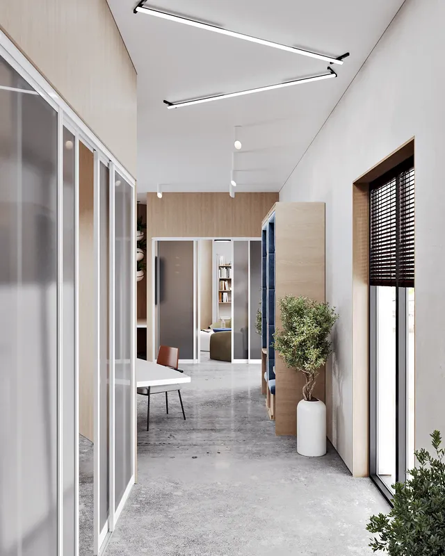 Modern office hallway with entrances to a glass-walled meeting room and a lounge area.