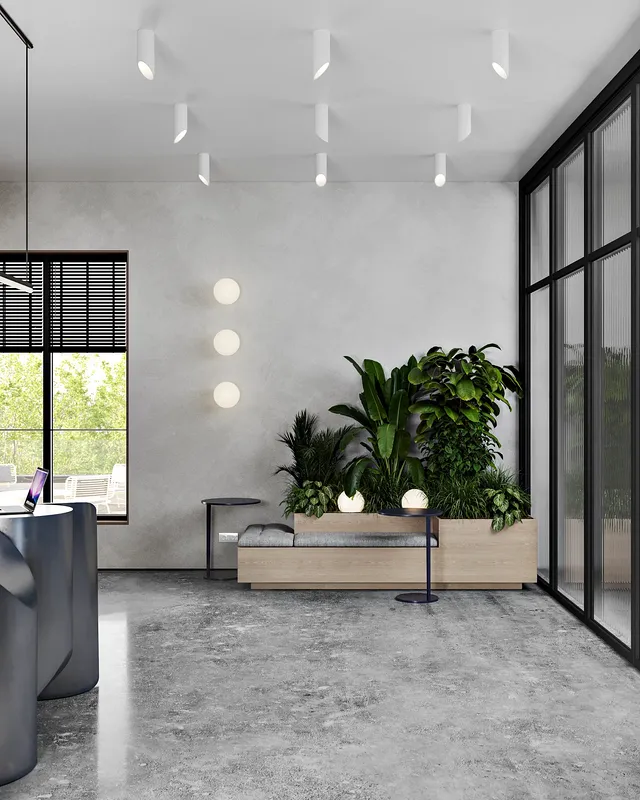 Reception waiting area with contemporary seating and a decorative floral arrangement.