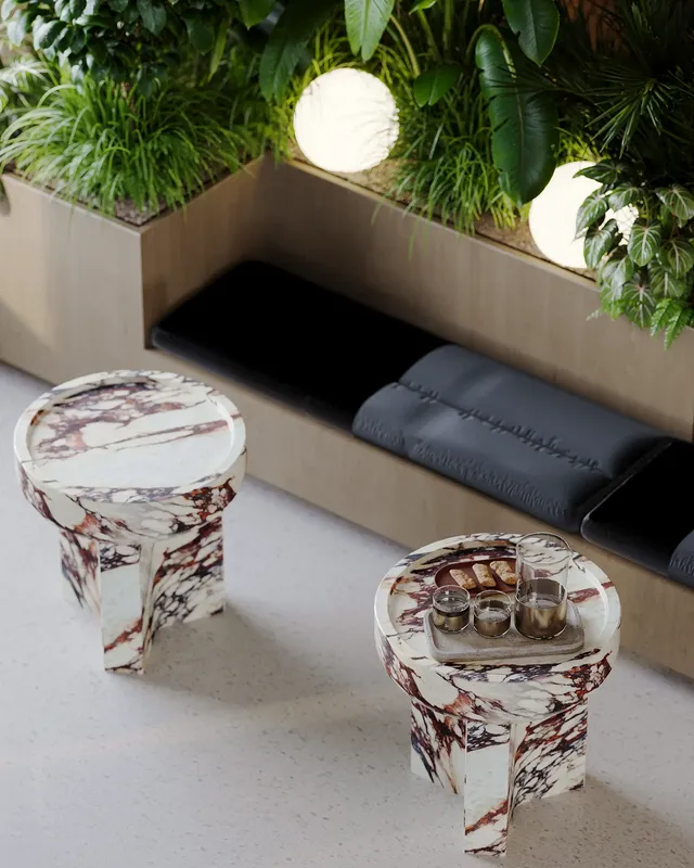Close-up of modern coffee tables in a sunlit waiting lounge by a window.