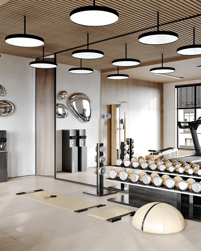 Gym hydration station next to a dumbbell rack and a large mirror.