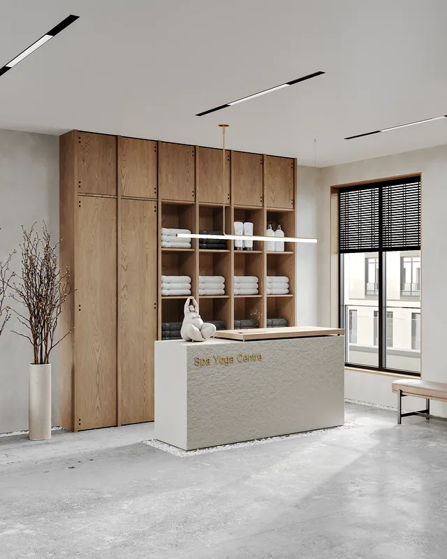 Clean, modern wellness center reception desk with a neatly stocked towel shelf.