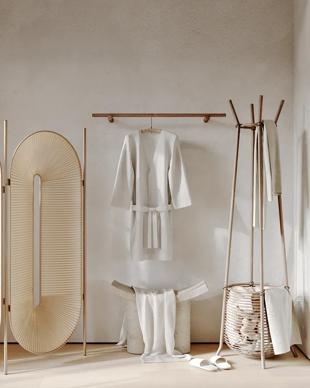 Private changing nook in a massage room, equipped with hangers and a modesty screen.