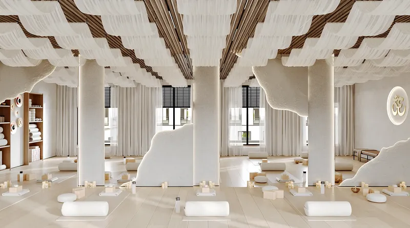 Bright yoga studio with yoga mats neatly arranged in front of a full mirrored wall.