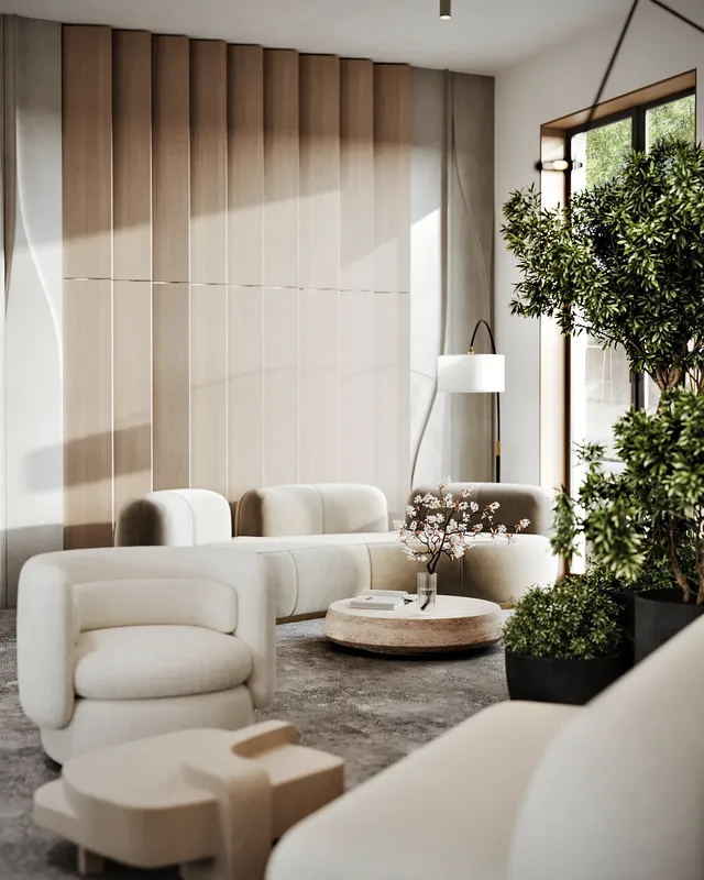 Sunlit entrance lounge by a window, with cozy sofas, armchairs, and large plant arrangements.