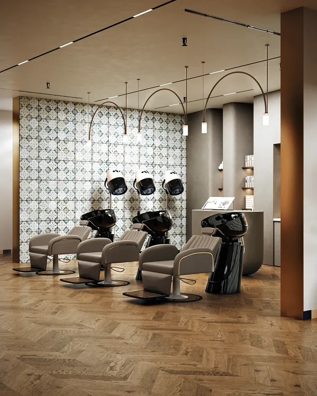 Wide view of the salon's hair washing area, featuring comfortable reclining chairs and basins.