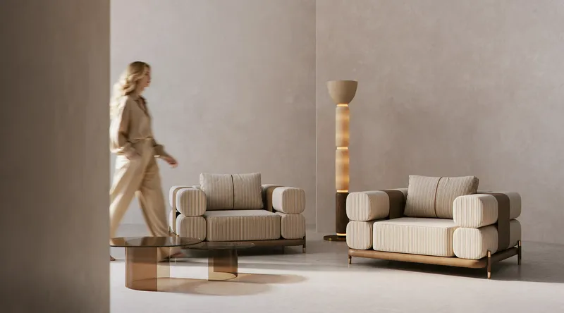 Frontal view of two stylish modern armchairs, with a woman approaching one.