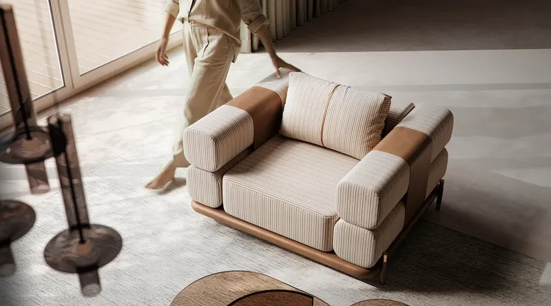 Top-down view of a stylish modern armchair with a person standing beside it.