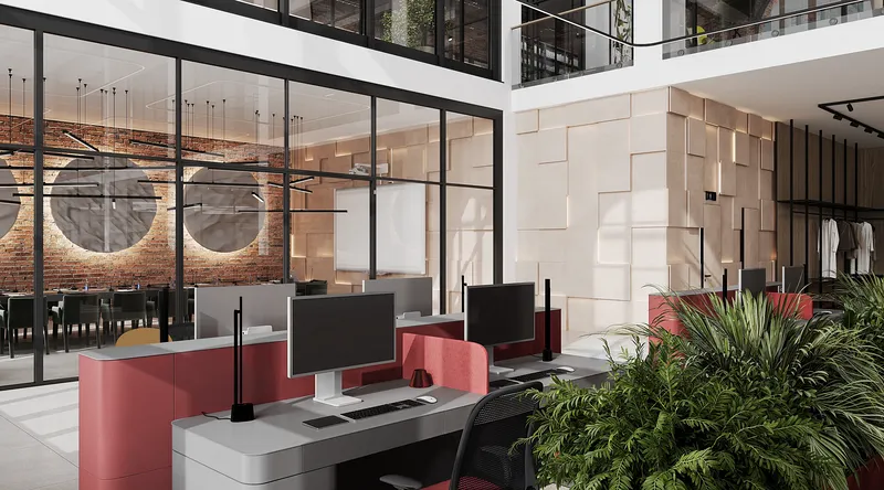 View of a glass-walled conference room from the main open-plan office workspace.