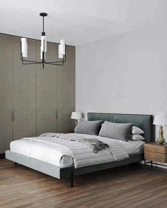 Angled view of a bed, wardrobe, and bedside tables with lamps.