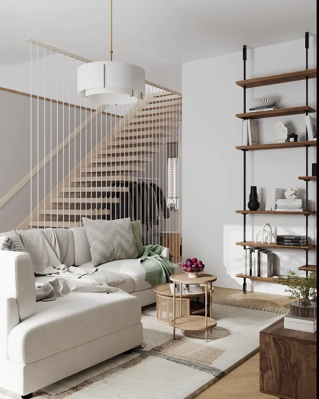 Angled view of a sofa, coffee tables, staircase, and storage shelves.