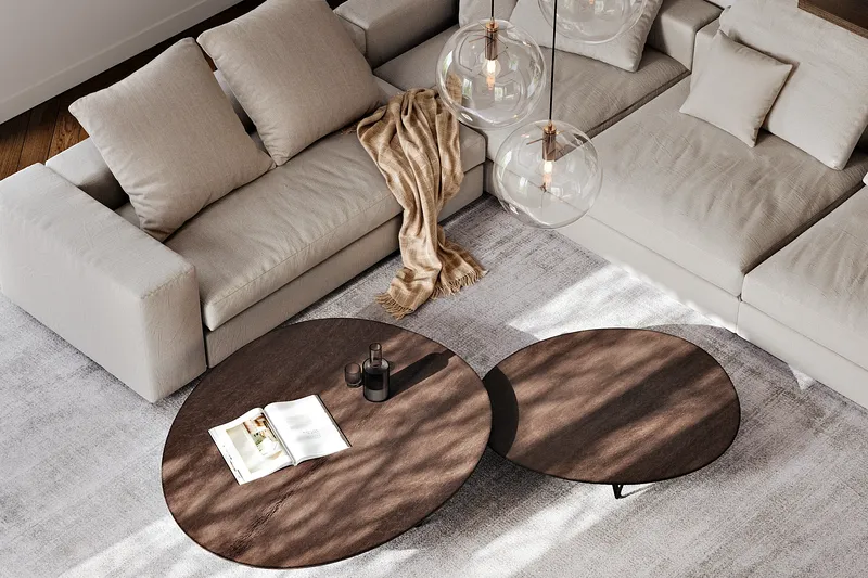 Top-down view of a sofa and coffee tables in a living room.