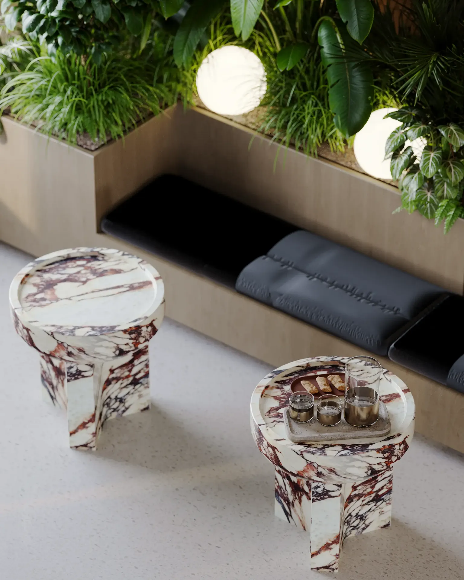 Close-up of modern coffee tables in a sunlit waiting lounge by a window.