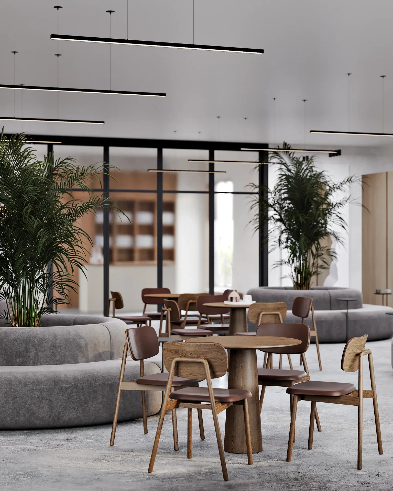 Cafe dining area featuring tables for four and stylish, round banquette sofas.