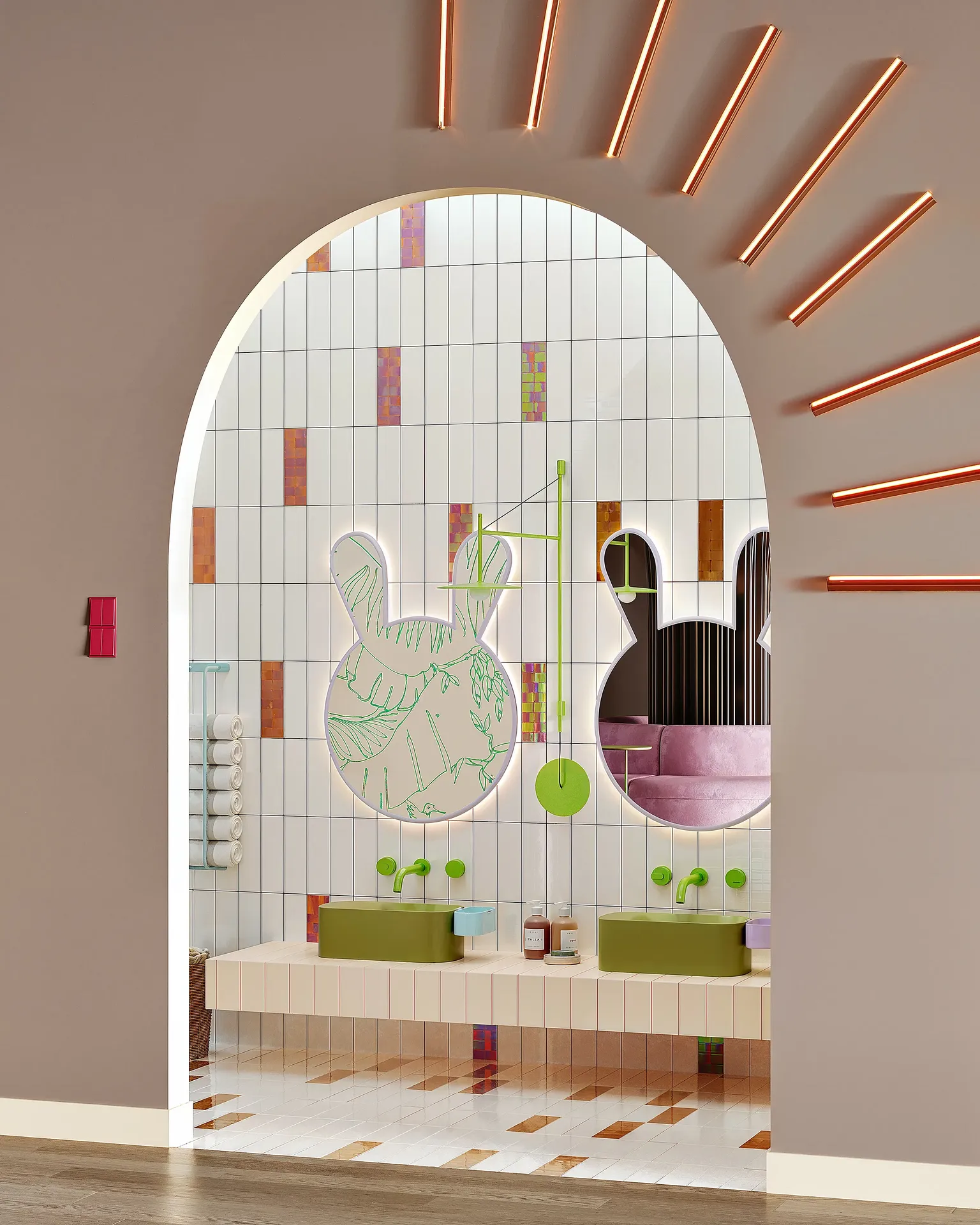 Bright children's restroom design with low-level sinks and colorful fixtures at the hand-washing station.