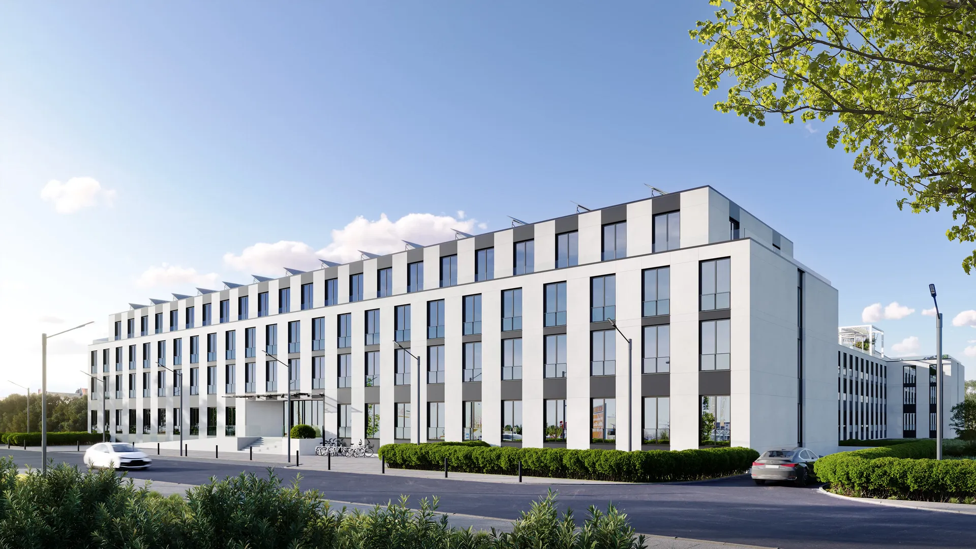 Sunlit corner view of the modern residential complex, highlighting its architectural facade and balconies.