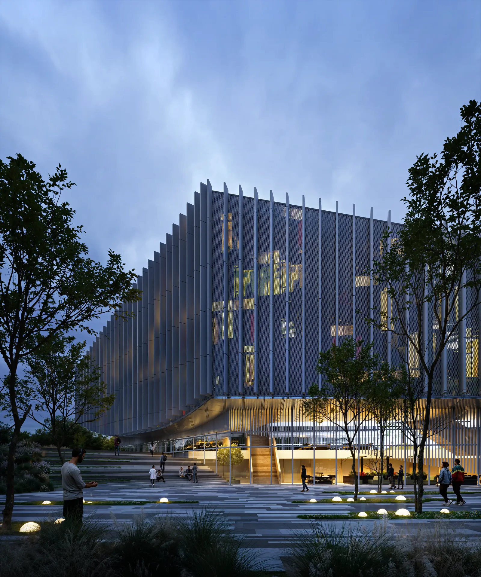 Striking evening view of the illuminated cultural center, highlighting its architectural lighting and public plaza with people.