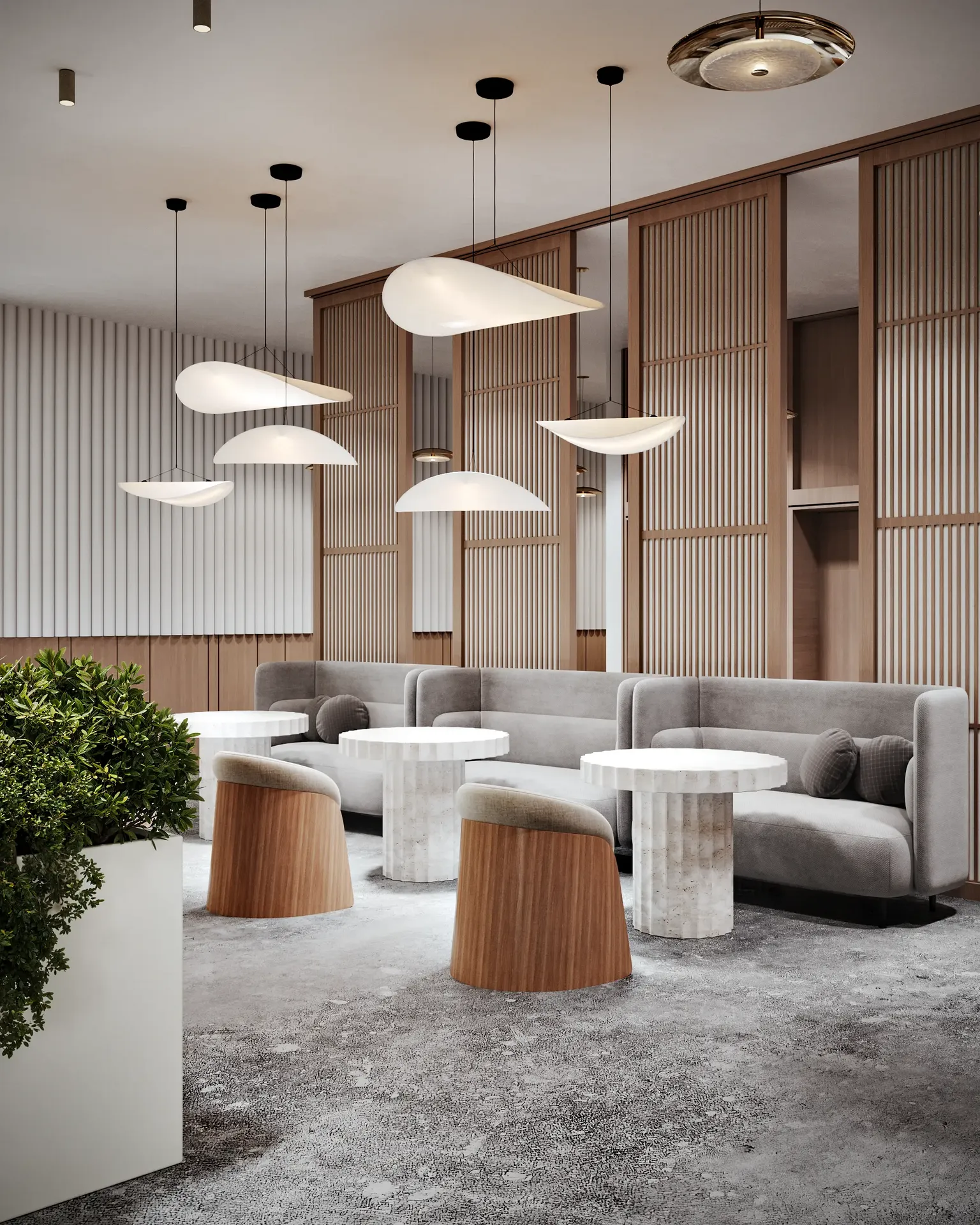 Two women collaborating in a modern elevator lobby lounge, featuring sofas and wood partitions.