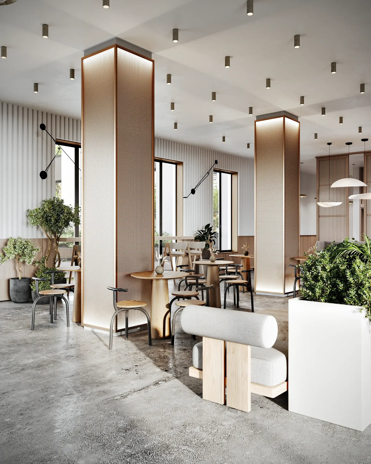 Open cafe area with group tables set among modern, structural columns in a spacious lobby.