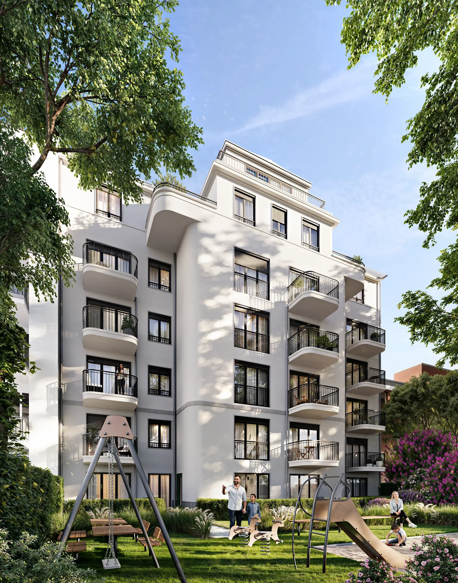 View of the residential building from a bright playground, with people relaxing on benches.