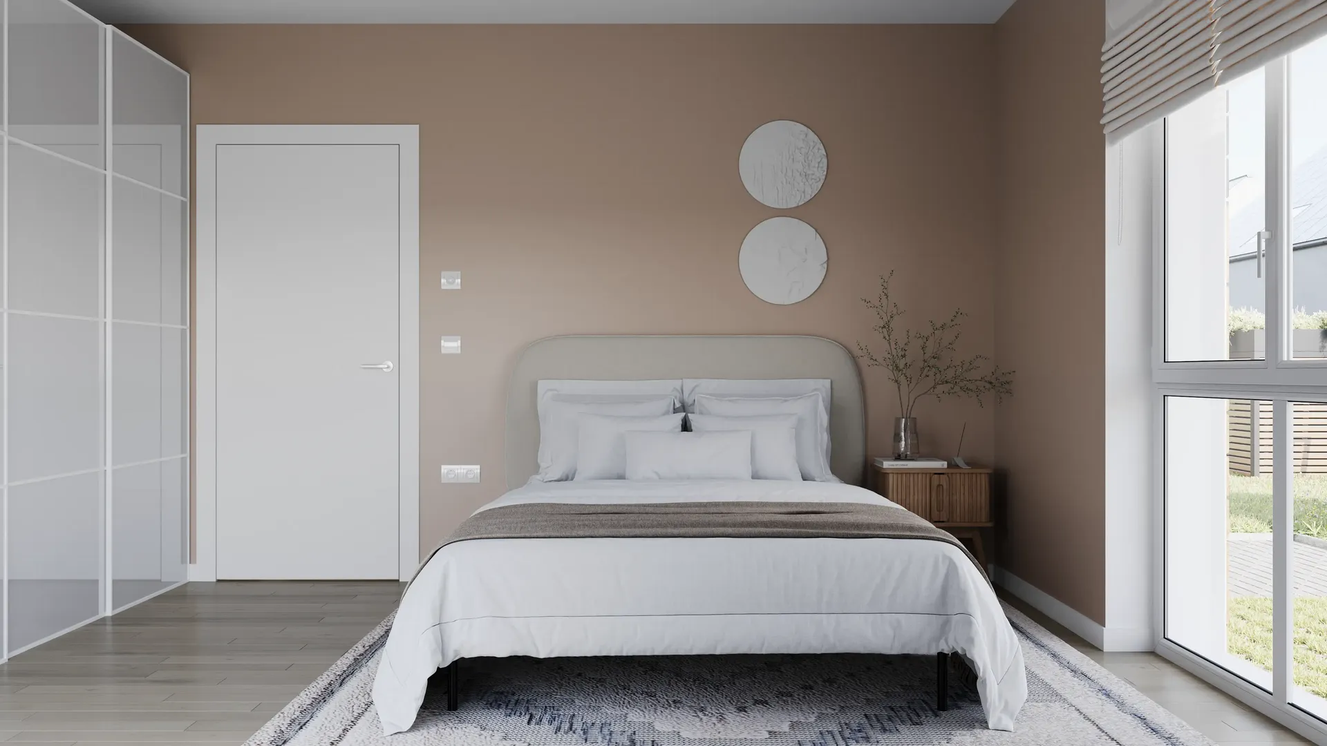 Front view of a bed, wardrobe, and room entrance.