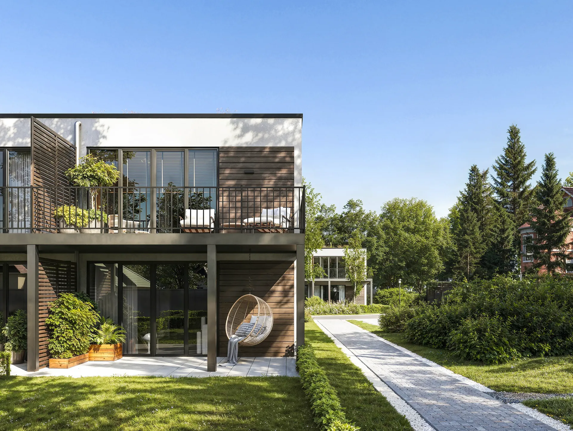 Front view of house facades, balconies, and walking path.