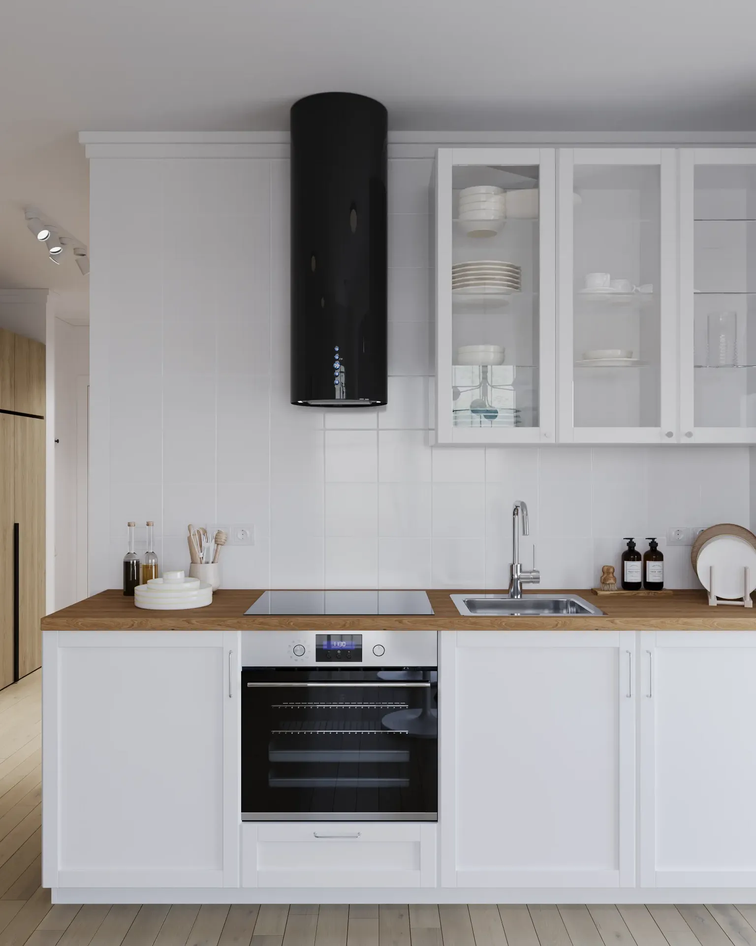 View of kitchen cabinetry, oven, hood, and cooktop.