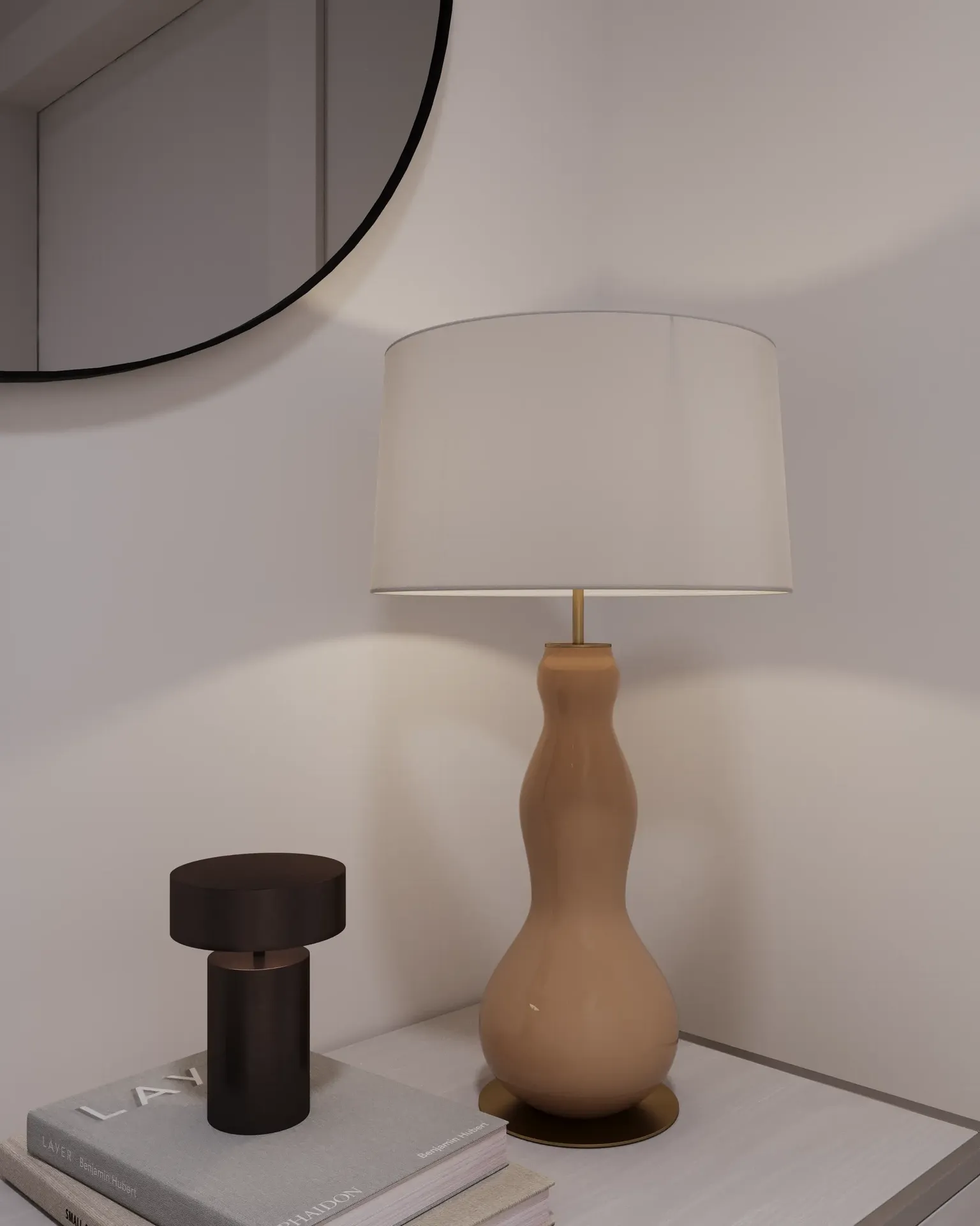 Close-up of a table lamp and decor on a console.