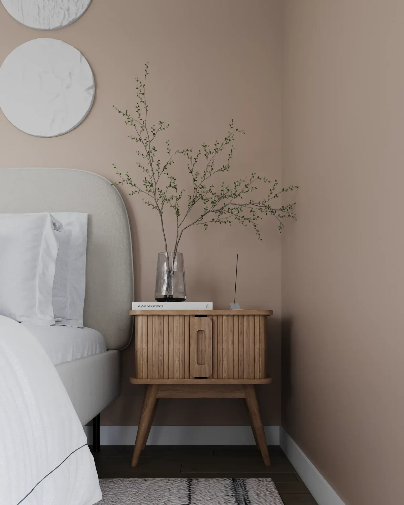 Bedside table with decor and part of the headboard.