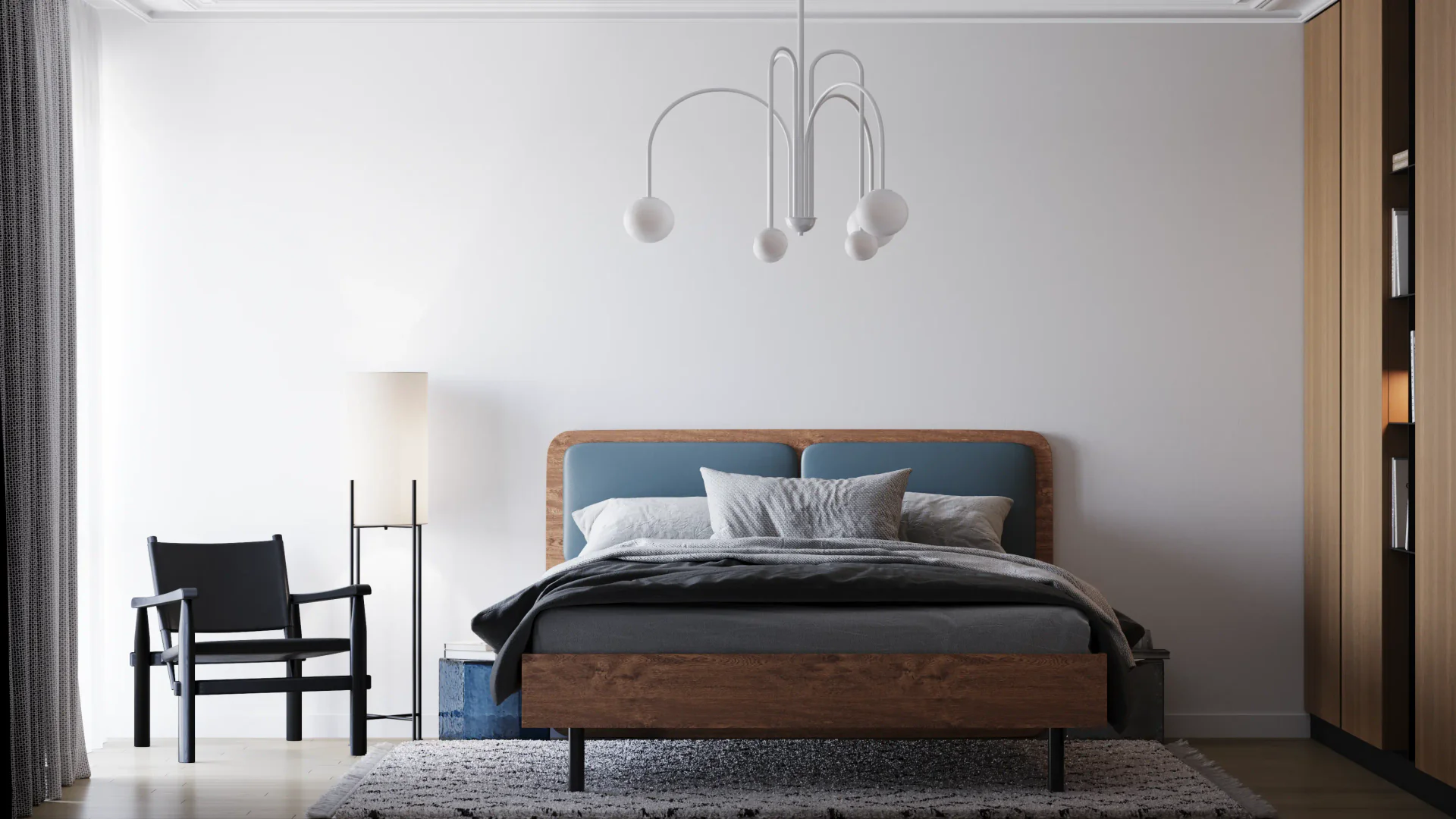 Front view of a bed, wardrobe, armchair, and floor lamp.