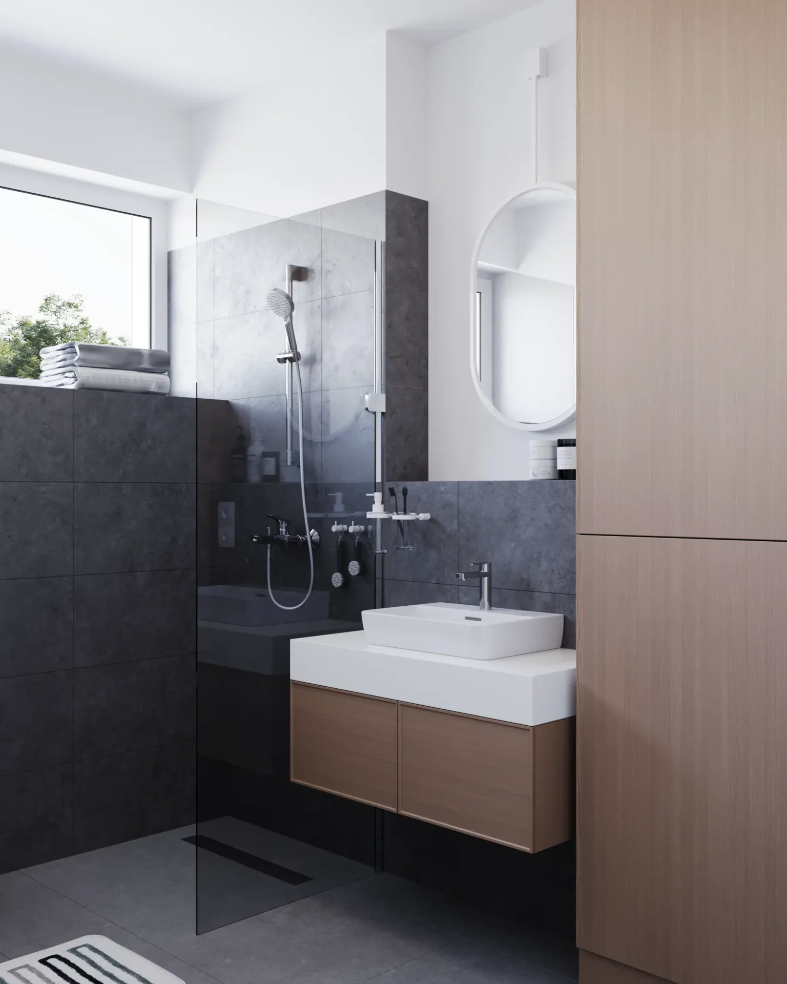 Angled view of a shower, sink vanity, and tall storage unit.