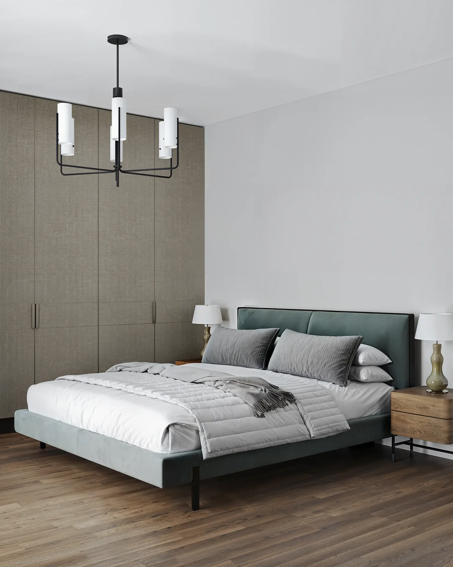 Angled view of a bed, wardrobe, and bedside tables with lamps.